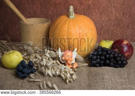 Baby Angel, Pumpkin, Apples And Grape.  Thanksgiving Day Holiday Concept