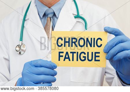 Doctor Holding Sign With Text Chronic Fatigue Closeup.