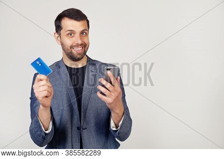Young Businessman Man With A Beard In A Jacket, Handsome Man Using A Credit Card To Pay Online Using