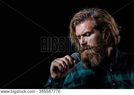 Man Singing With Microphone. Male Singing With A Microphones. Bearded Man In Karaoke Sings A Song In