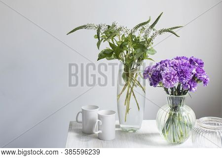 Bridal Bouquets Of Lilac Carnations In A Four Round Glass Vases Different Sizes As Table Decoration.