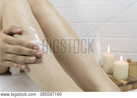 A Woman Applies A Moisturizer To The Skin Of Her Legs. Problem Skin, Strawberry Legs, Chicken Skin, 