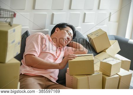 Asian Men Are Falling Asleep Because To Tired Of Handling The Order-based Goods From Online Customer