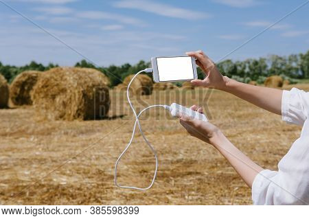 Mock Up Of A Smartphone And The Power Bank, In The Hand Of A Girl.