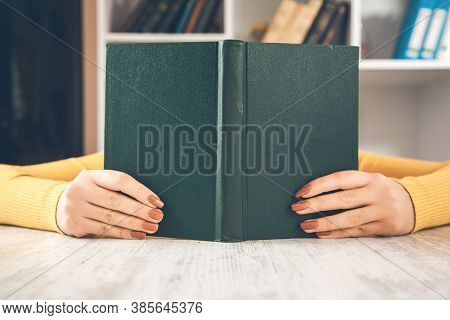 Woman Hand Book On Face In Dask