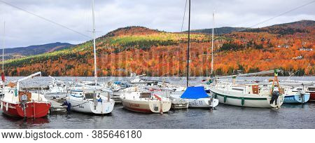 MONT TREMBLANT, QUEBEC -12 OCTOBER 2019:  Several boats are docked at Lac Tremblant, is one of top four season recreational destinations in Canada.
