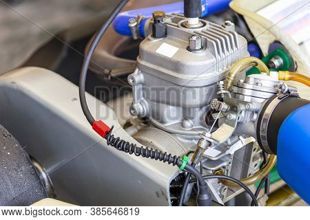 Close Up Carburetor And Cable Choke Assembly With Body And Cylinder Head Of 4 Stroke Engine Of Sport