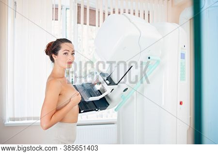 Healthy Young Woman Doing Cancer Prophylactic Mammography Scan At Hospital.