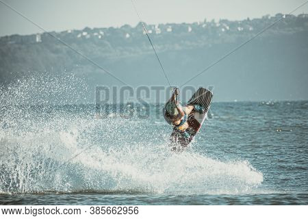 Wakeboarding At The Sea Jumping High Doing A Backflip.