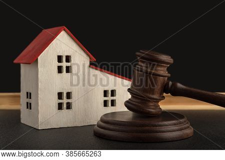 Judges Hammer And Model Of House. Confiscated Housing. Resolving Property Disputes