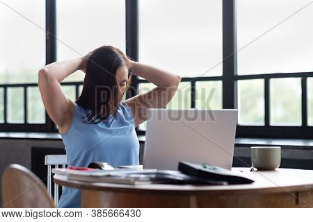 Young Caucasian Woman Stretching Side Of Neck Muscle During Work Break At Home