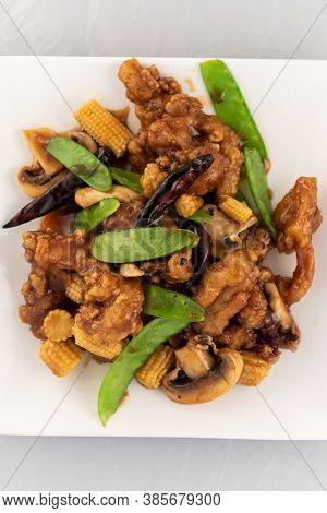 Appetizing Plate Tempting The Tastebuds With Tangerine Flavored Chicken In Perfect Serving Size.