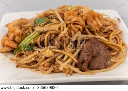 Detail View Of Appetizing Plate Tempting The Tastebuds With Pan Fried Soft Noodles In Perfect Servin
