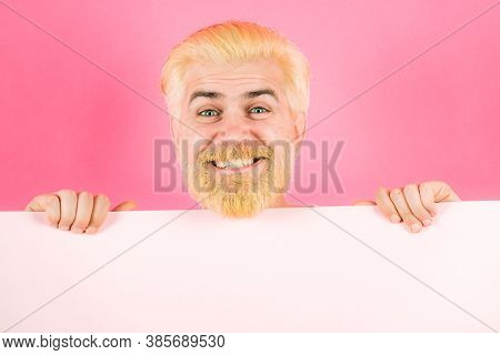 Smiling Man Holding Empty Blank Paper Board With Copy Space For Text. Man Holding Empty Sheet Of A P