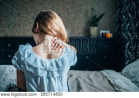 Young Girl Massages Back Pain. Selective Focus.