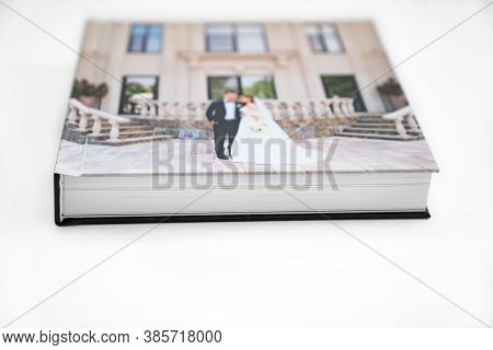 Wedding Photobook With Thick Pages On A White Table. Convenient, Beautiful And Long-lasting Storage 