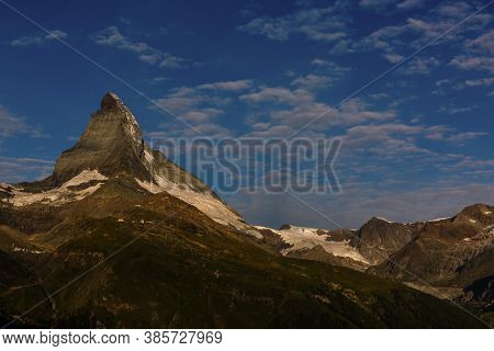 Zermatt, Switzerland. Matterhorn Mountain Near Grindjisee Lake With Flowers In The Foreground. Canto