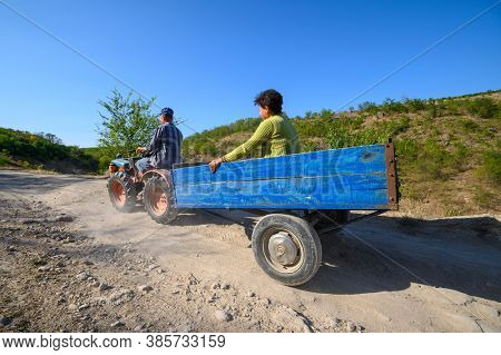 Socola village, Soldanesti, Moldova, September 2020: Mini tractor at mountain road iwith passenger. This mode of working transport bacomes popular at bad roads in this region.