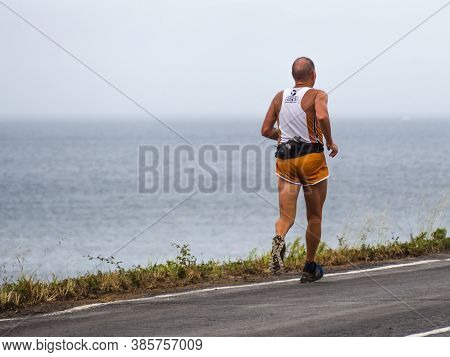 Muxía, A Coruña, Spain; 08/17/2020: Runner Training On A Seaside Road