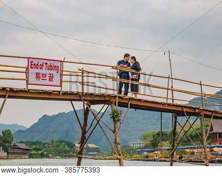 Vangvieng/lao-10 Dec 2017:unacquainted People On The Wooden Bridge And Kayaking At Namsong River Van