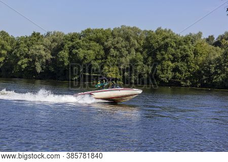 Modern Speedboat Sailing On Forest Background. Summer Leisure And Water Activity. Rest On The River 