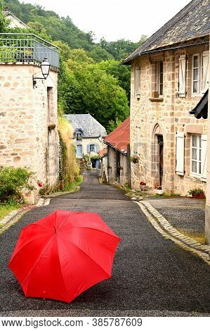 Red Umbrella On A Street In A Village