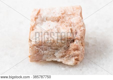 Closeup Of Sample Of Natural Mineral From Geological Collection - Rough Feldspar Rock On White Marbl