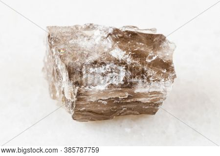 Closeup Of Sample Of Natural Mineral From Geological Collection - Unpolished Smoky Quartz Rock On Wh