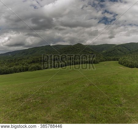 Panorama View With Meadows And Pasture Land And Gray Clouds Near Runina Village