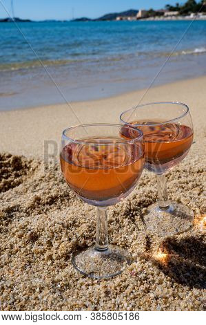 Two Glasses Of Local Rose Wine On White Sandy Beach And Blue Mediterranean Sea On Background, Near L