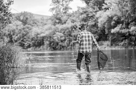 Calling Fly-fishing A Hobby. Fisherman With Fishing Rod. Retired Bearded Fisher. Trout Bait. Hobby A