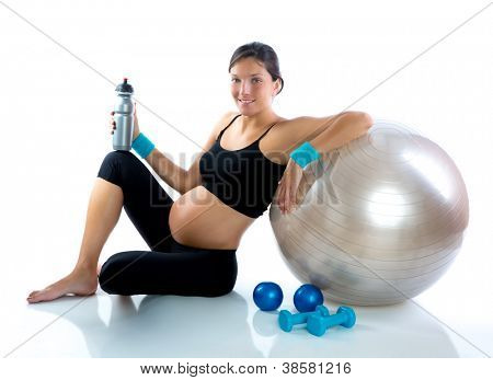 Bella donna incinta presso palestra fitness rilassata con palla aerobica
