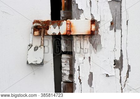 Rusty old door latch on weathered wood 