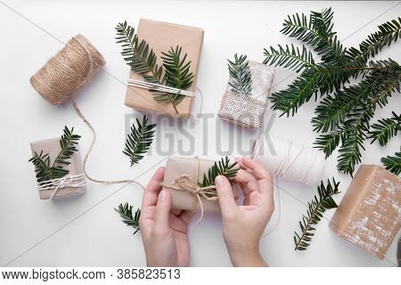 Hands Hold Hand Made Gifts For Christmas On White Background