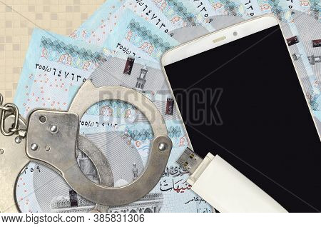 5 Egyptian Pounds Bills And Smartphone With Police Handcuffs. Concept Of Hackers Phishing Attacks, I