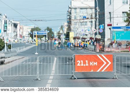 Red Signpost 21.1 Km Sign To Guide Runners During The Half Marathon On The Street