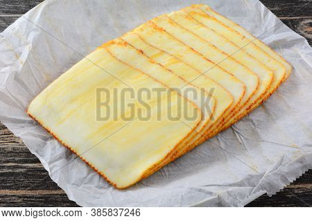 Stack Of Muenster Cheese Slices On White Paper Butcher Paper