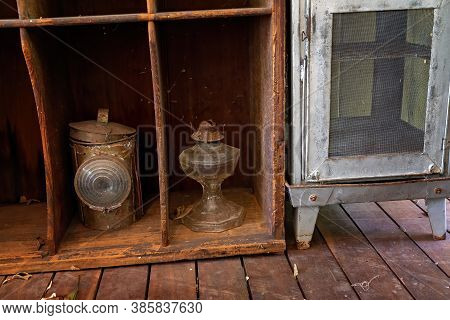 Decrepit Vintage Display Of Food Safe And Lanterns From Yesteryear