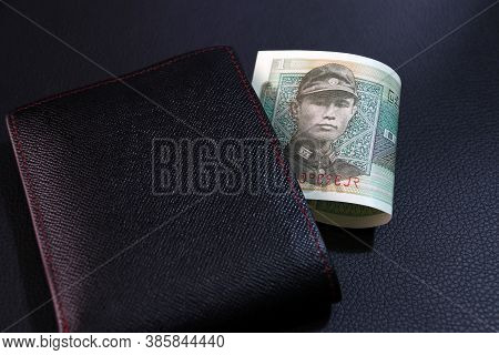 One Of Banknote Currency Myanmar Kyats With Black Wallet On The Black Floor. It Is The Retro Money. 