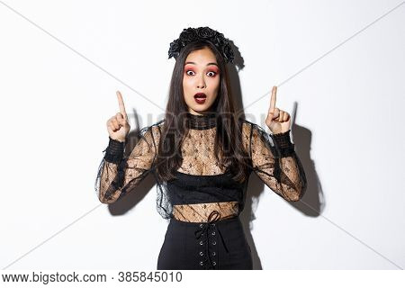 Impressed Asian Girl In Black Lace Dress And Wreat Turn Your Attention On Halloween Promo, Making An
