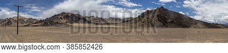 Panorama Of Bare Mountains In The Valley Of The River Murghab With Dark Rain Clouds Near The Village