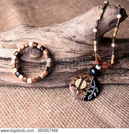 Handmade Wooden Necklace And Earring On The White And Black Background