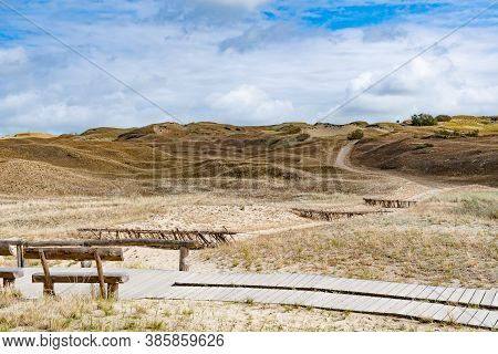 Wooden Bench And Path In Nagliai Nature Reserve In Neringa, Lithuania. Dead Dunes, Sand Hills Built 
