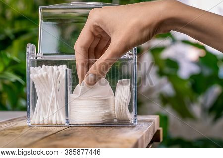 Woman's Hand Pulls Out A White Cotton Pad From The Organizer Close Up