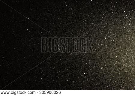 Black Texture With Micro-relief And Glitter. Black Glitter Texture Illuminated From Right