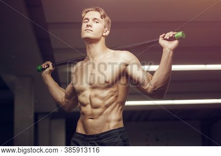 Fitness Man At Workout In Gym With Bodybar Stretching Muscles