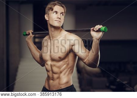 Fitness Man At Workout In Gym With Bodybar Stretching Muscles