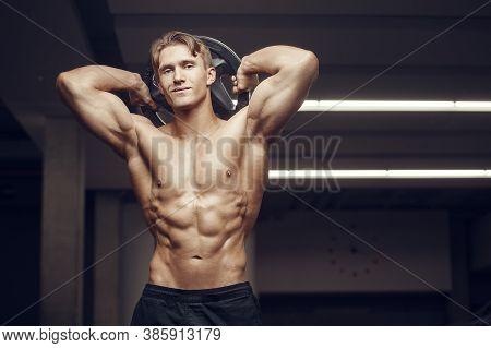 Fitness Man At Workout In Gym With Bodybar Stretching Muscles. Workout Fitness And Bodybuilding Heal