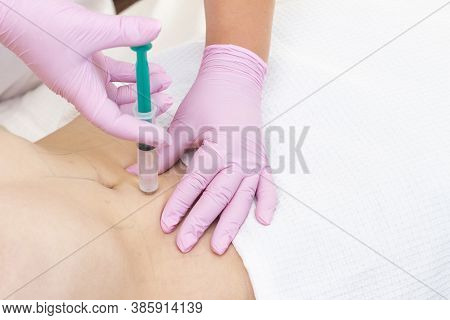 Lipolytic Injections Are Placed In The Stomach. Female Hands In Pink Gloves Inject A Young Woman Int