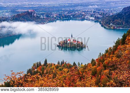 Aerial View Of Church Of Assumption In Lake Bled, Slovenia In The Aurumn With Colorful Trees